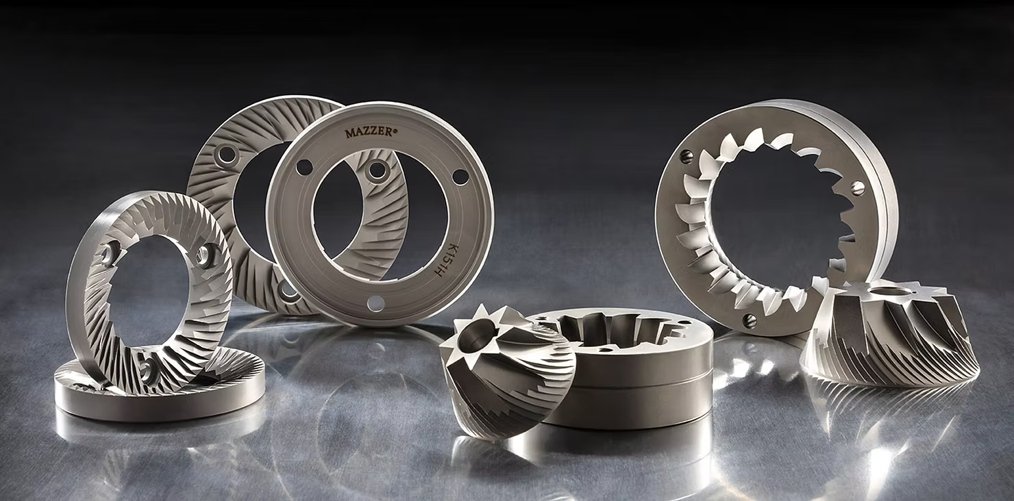 Flat vs Conical Burr coffee grinder parts displayed on a metallic surface showcasing their design differences.